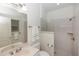 Bright bathroom features a walk-in shower and a vanity with a light countertop and a large mirror at 1908 S Farm Rd, Deland, FL 32720