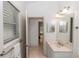 Bathroom with a light colored vanity with an open door leading to another room at 1908 S Farm Rd, Deland, FL 32720
