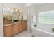 Elegant bathroom featuring granite counters, tiled floors, and a large soaking tub at 1908 S Farm Rd, Deland, FL 32720