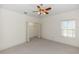 Bedroom with a ceiling fan, window, and closet space with carpeted floors at 1908 S Farm Rd, Deland, FL 32720