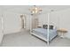 Bright primary bedroom with neutral carpet, en-suite bath, and two windows at 1908 S Farm Rd, Deland, FL 32720