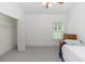 Carpeted bedroom with a ceiling fan, bed, window, and closet at 1908 S Farm Rd, Deland, FL 32720