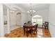 Formal dining room with wood-patterned tile flooring, chandelier, and a view of the front entry at 1908 S Farm Rd, Deland, FL 32720