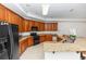 Open kitchen with wooden cabinets, granite countertops and an expansive island at 1908 S Farm Rd, Deland, FL 32720