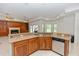 Kitchen with granite countertop island and sink open to a living area with fireplace and built-ins at 1908 S Farm Rd, Deland, FL 32720