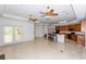Spacious kitchen with a large island, tile flooring, and ample cabinet space offers open-concept living at 1908 S Farm Rd, Deland, FL 32720