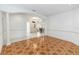 Open-concept living room with tile floors and an arched entryway, great for entertaining at 1908 S Farm Rd, Deland, FL 32720