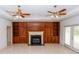 Living room with built-in shelving, a fireplace, and tile flooring at 1908 S Farm Rd, Deland, FL 32720