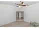 Spacious living room with carpet, ceiling fan, and an entry to another room at 1908 S Farm Rd, Deland, FL 32720