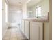 Bright bathroom featuring a shower with sliding glass door and a vanity with white cabinets at 2006 Stone Abbey Blvd, Orlando, FL 32828