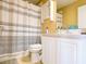 Bathroom with shower featuring striped curtain, a white vanity and a cabinet at 2006 Stone Abbey Blvd, Orlando, FL 32828
