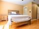 Cozy bedroom showcasing a wood bed frame, a patterned white coverlet and matching nightstand at 2006 Stone Abbey Blvd, Orlando, FL 32828