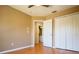 Bright bedroom featuring a double closet door, a window and a laminate wood floor at 2006 Stone Abbey Blvd, Orlando, FL 32828