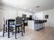 Eat-in kitchen featuring stainless steel appliances, dark countertops, and modern lighting at 2006 Stone Abbey Blvd, Orlando, FL 32828