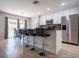 Beautiful kitchen with white cabinets, stainless steel appliances, an island with bar stool seating, and modern finishes at 2006 Stone Abbey Blvd, Orlando, FL 32828