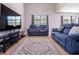 Comfortable living area featuring modern furniture, hardwood floors, and a large window for natural light at 2006 Stone Abbey Blvd, Orlando, FL 32828