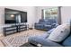 Inviting living room featuring comfortable seating, hardwood floors, and a large TV at 2006 Stone Abbey Blvd, Orlando, FL 32828