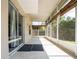Long, sunlit screened patio with tile floors, privacy screens and sliding glass door at 2006 Stone Abbey Blvd, Orlando, FL 32828