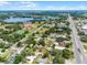 Aerial view of home surrounded by trees, near a lake and city amenities at 25 E Pinecrest Ave, Eustis, FL 32726