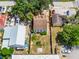 Aerial view of the home showing proximity to nearby buildings and backyard at 25 E Pinecrest Ave, Eustis, FL 32726