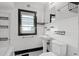 Cozy bathroom featuring black and white tile, pedestal sink, and classic subway tile shower at 25 E Pinecrest Ave, Eustis, FL 32726