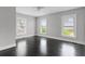Bright and airy bedroom with refinished hardwood floors, neutral walls, and large windows at 25 E Pinecrest Ave, Eustis, FL 32726