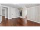 Spacious bedroom with hardwood floors and white-wood paneled walls and interesting alcove at 25 E Pinecrest Ave, Eustis, FL 32726