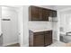 Clean kitchen featuring neutral countertops, wood-look cabinets, and doorway leading to another room at 25 E Pinecrest Ave, Eustis, FL 32726
