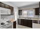 Functional kitchen with light countertops, tiled floors, and view from window allowing for plenty of natural light at 25 E Pinecrest Ave, Eustis, FL 32726