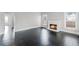Bright living room featuring refinished floors, a brick fireplace, and abundant natural light at 25 E Pinecrest Ave, Eustis, FL 32726