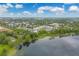 Aerial view of community on a lake showcasing the landscaping and buildings at 2550 Alafaya Trl # 9303, Orlando, FL 32826