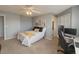 Spacious bedroom featuring a desk, bed with decorative pillows, ceiling fan, and closet space at 2550 Alafaya Trl # 9303, Orlando, FL 32826