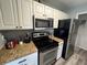 Compact kitchen featuring granite countertops, stainless steel appliances, and ample storage at 2550 Alafaya Trl # 9303, Orlando, FL 32826