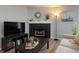 Comfortable living room with a stylish fireplace, a TV, and modern decor at 2550 Alafaya Trl # 9303, Orlando, FL 32826