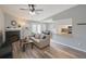 Bright open-concept living room featuring a fireplace, dining area, and pass-through kitchen at 2550 Alafaya Trl # 9303, Orlando, FL 32826