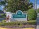 Waterford Landing Condominiums sign featuring lush landscaping under a blue sky at 2550 Alafaya Trl # 9303, Orlando, FL 32826