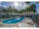 Resort-style pool with lounge chairs and palm trees, perfect for relaxation and enjoying the beautiful surroundings at 2550 Alafaya Trl # 9303, Orlando, FL 32826