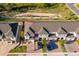 Aerial view of townhomes with well-maintained landscaping, ample parking, and updated roof at 2596 Penguin Blvd, Davenport, FL 33837