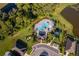 Aerial view of a stunning community pool with manicured landscaping and a gazebo at 2596 Penguin Blvd, Davenport, FL 33837