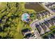 Aerial view of a community pool and amenities, surrounded by lush landscaping and residences at 2596 Penguin Blvd, Davenport, FL 33837