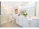 Bathroom featuring dual sinks, a glass-enclosed shower, and modern fixtures for a clean and comfortable feel at 2596 Penguin Blvd, Davenport, FL 33837