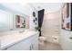 Bright bathroom featuring a modern vanity, decorative art, and a shower-tub combination at 2596 Penguin Blvd, Davenport, FL 33837