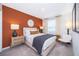 Bedroom with accent wall, white curtains, and warm, inviting decor at 2596 Penguin Blvd, Davenport, FL 33837