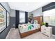 Stylized bedroom featuring modern decor, a comfortable bed, and bright natural light at 2596 Penguin Blvd, Davenport, FL 33837