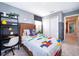 Comfortable bedroom with modern gray walls, a desk, and convenient closet storage at 2596 Penguin Blvd, Davenport, FL 33837