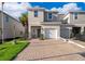 Two-story townhouse featuring a one car garage, nicely landscaped yard, and a brick driveway at 2596 Penguin Blvd, Davenport, FL 33837