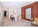 Hallway with carpet, bench, decorated accent wall with mirror, and access to rooms at 2596 Penguin Blvd, Davenport, FL 33837