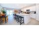 Open kitchen featuring white cabinets, a large island with bar seating, and stainless steel appliances at 2596 Penguin Blvd, Davenport, FL 33837