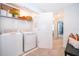 Well-lit laundry area with modern washer and dryer, featuring convenient shelving at 2596 Penguin Blvd, Davenport, FL 33837
