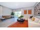 Bright living room featuring a comfortable sofa, stylish decor, and a sliding glass door at 2596 Penguin Blvd, Davenport, FL 33837